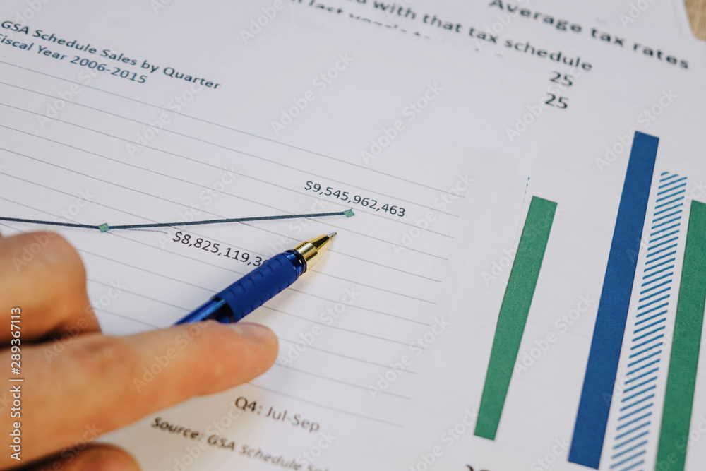 ballpoint pen indicates income graphs lying on the table ballpoint pen indicates income graphs lying on the table