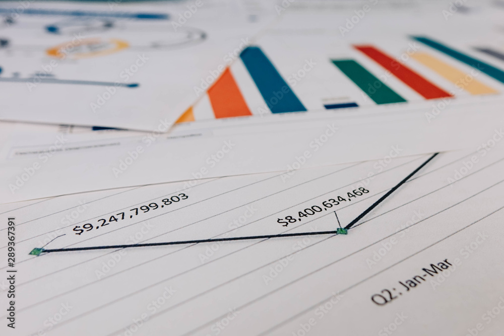 ballpoint pen indicates income graphs lying on the table. ballpoint pen indicates income graphs lying on the table.