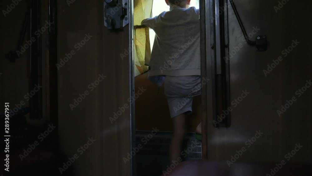 Boy looking out old train window outside, in the evening, travel. Boy looking out old train window outside, in the evening, travel.