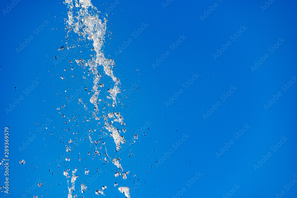 Flying water drops on blue background