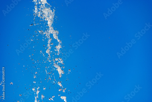 Flying water drops on blue background