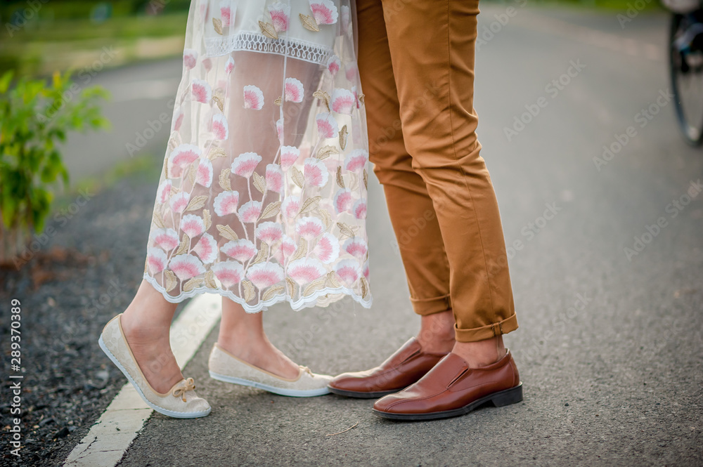 Male and female feet stand together