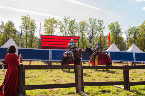 Fototapeta Naklejka Na Ścianę i Meble -  Reconstruction of the joust at the knightly tournament among equestrian knights in full armor.