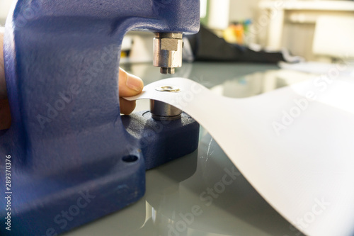 Obraz na plátně Advertising technology / Banner eyelets with eyelet press