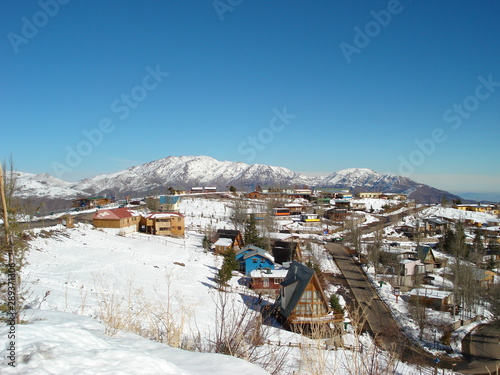 Village covered by snow. In the Background mountains and blue sky. Santiago, Chile, Andes 