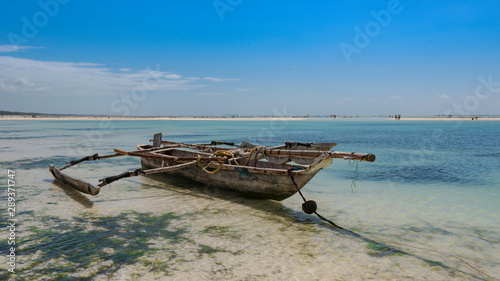 old fishing boat on the beach of zanzibar