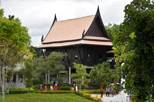 Kanchanaburi  Thailand  09.09.2019  Beautiful garden  lake  traditional Thai  Siamese clothes  buildings of  Mallika City R.E. 124  a heritage  retro-city reflecting the real past Siamese lifestyle