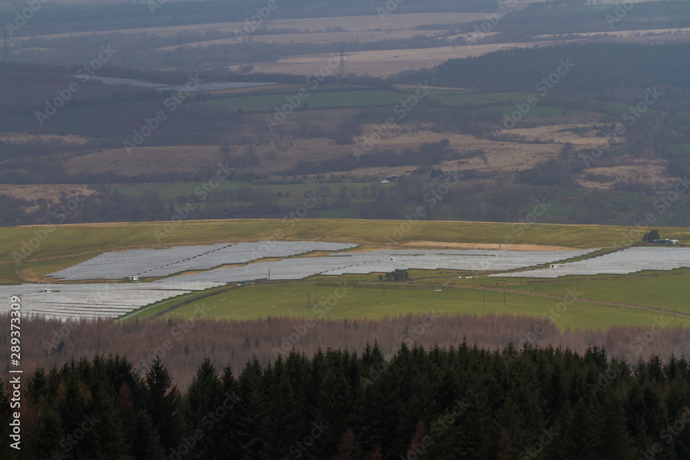 solar panel farm in View over Welsh countryside with, the Vale of Neath, zoom solar panel farm in View over Welsh countryside with, the Vale of Neath, zoom
