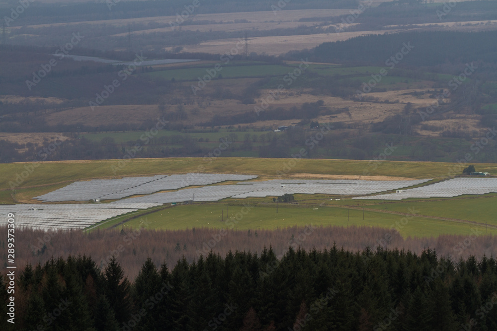 solar panel farm in View over Welsh countryside with, the Vale of Neath, zoom