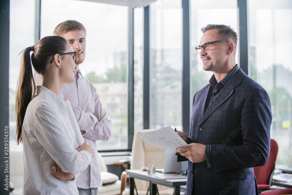 Three businesspeople discussing and planning concept in a office Three businesspeople discussing and planning concept in a office