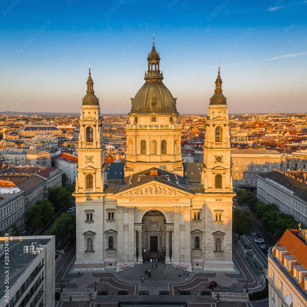 Budapest, Hungary - Aerial drone view of the beautiful St. Stephen's Basilica at sunset with warm summer afternoon lights and clear blue sky Budapest, Hungary - Aerial drone view of the beautiful St. Stephen's Basilica at sunset with warm summer afternoon lights and clear blue sky