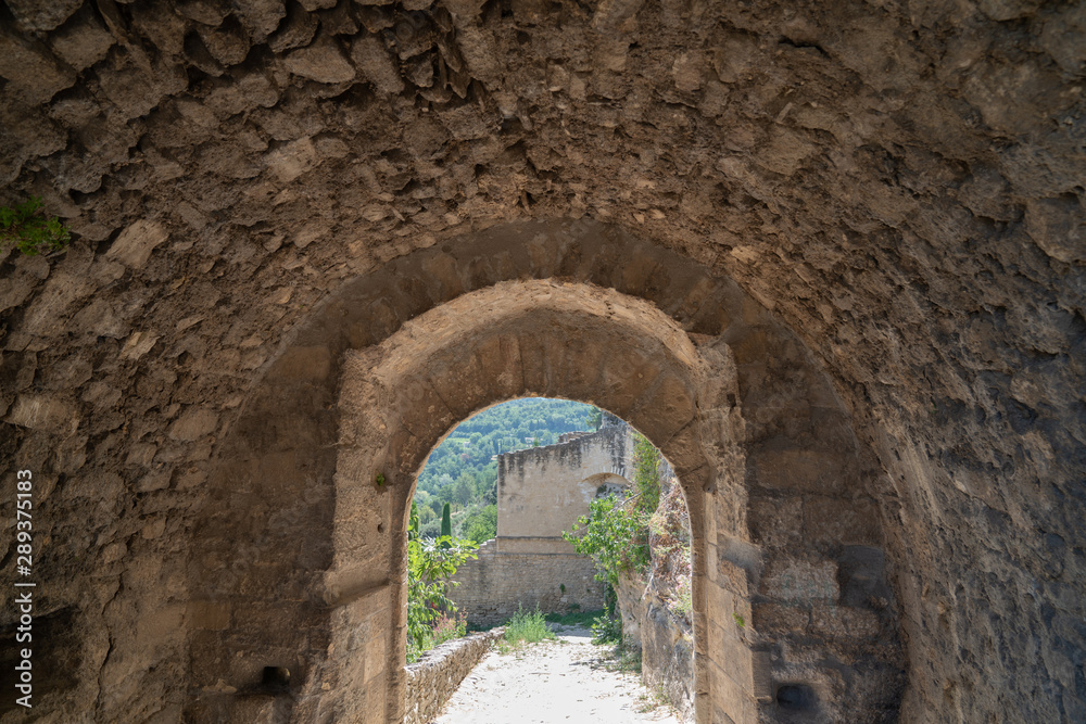 medieval arch stone in alley village of ménerbes in Luberon Provence France