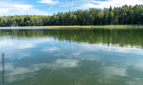 beautiful lake view, beautiful sky, Calm lake reflection against the blue sky with white clouds, Valdis lake, Turna, Latvia photo