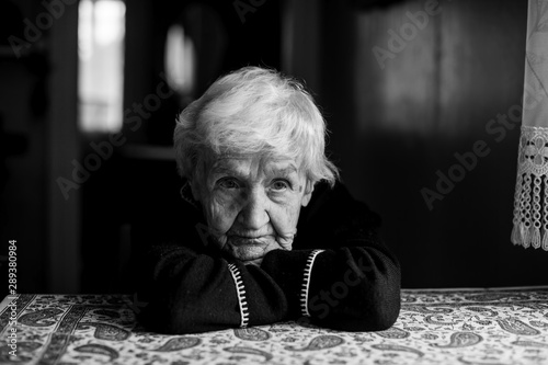 Black and white portrait of a sad old lady. Care for lonely pensioners.