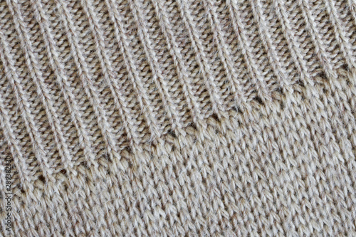 An example of combining different styles of knitting on one fragment of a woolen Scandinavian sweater. Diagonal pattern. Warm clothes for winter cold. Texture for design or research