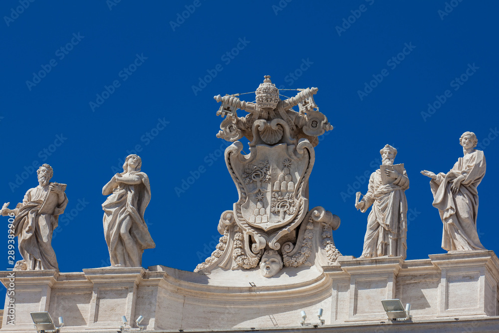 Detail of the Chigi coats of arms and the statues of saints that crown the colonnades of St. Peter Square built on 1667 on the Vatican City