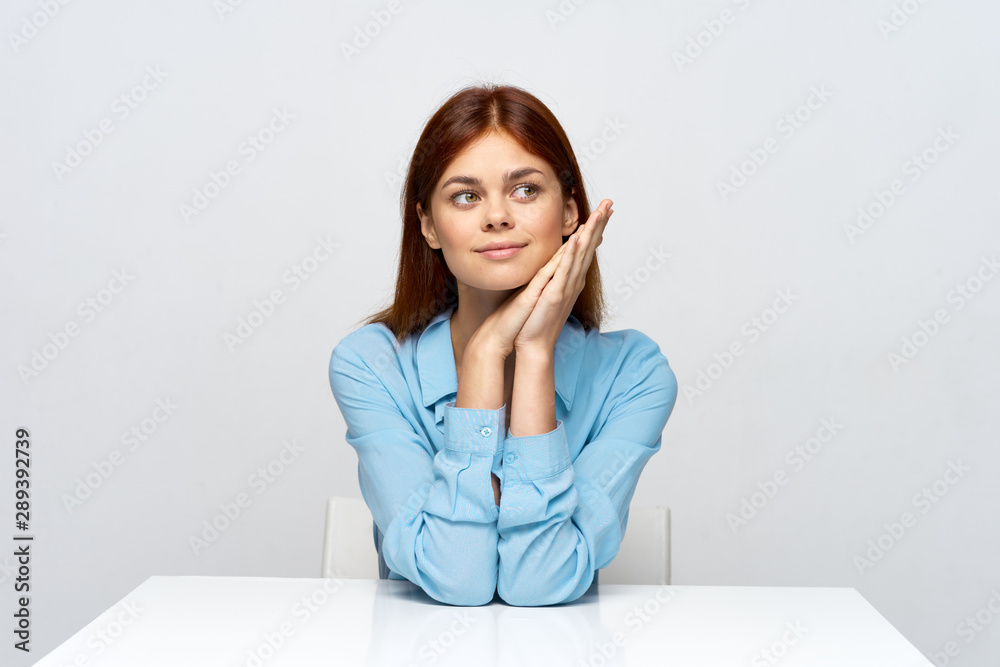 portrait of a young woman sitting at her desk portrait of a young woman sitting at her desk