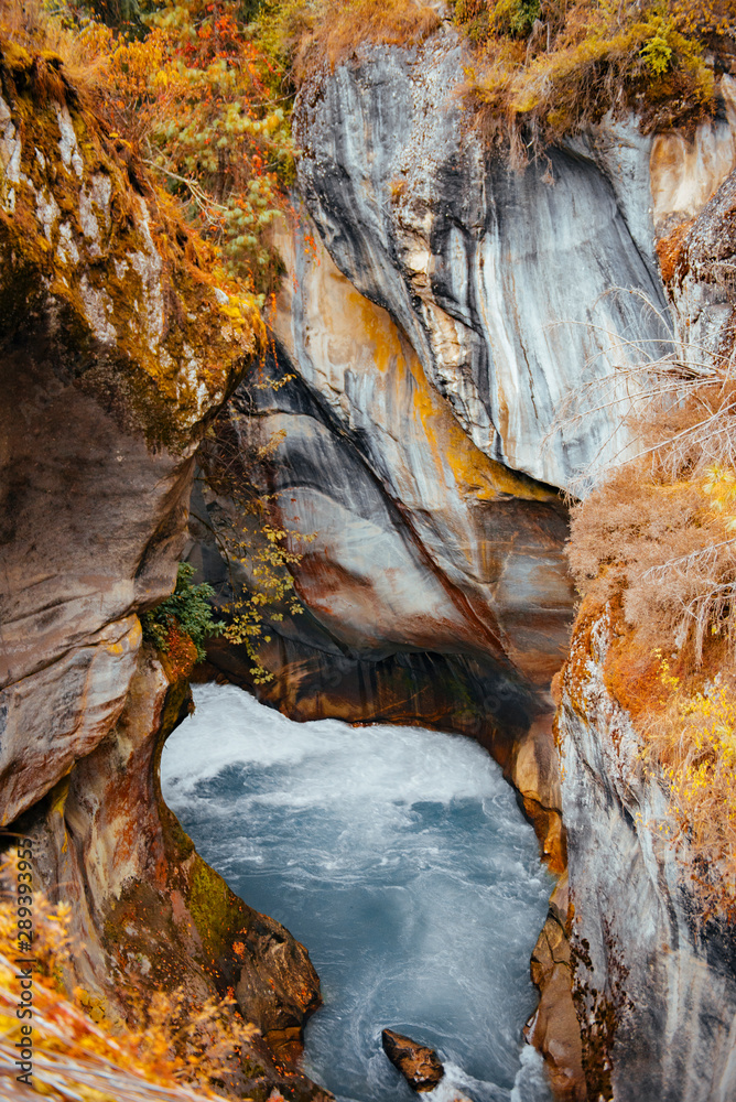 River flows trough rocky valley in Himalaya mountains in Nepal. River flows trough rocky valley in Himalaya mountains in Nepal.