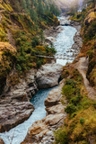 River flows trough rocky valley in Himalaya mountains in Nepal.