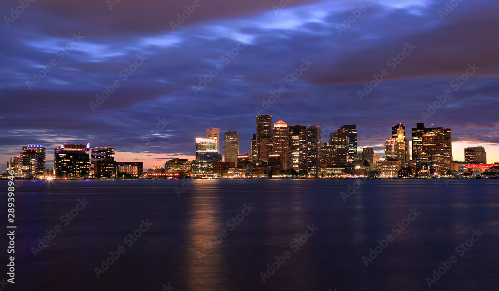 Boston skyline at night, with skyscrapers reflection on the ocean, Massachusetts, USA