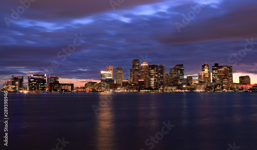Boston skyline at night  with skyscrapers reflection on the ocean  Massachusetts  USA
