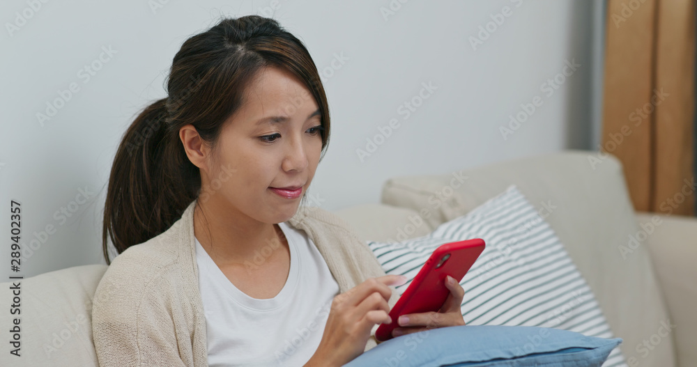 Woman check on smart phone at home Woman check on smart phone at home