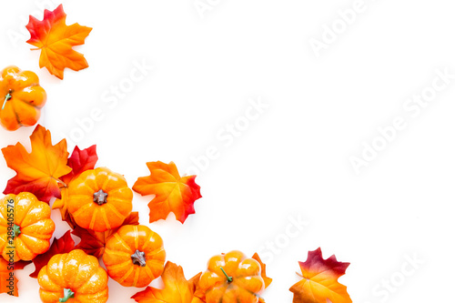 Autumn background with leaves and pumpkins on white top view space for text frame