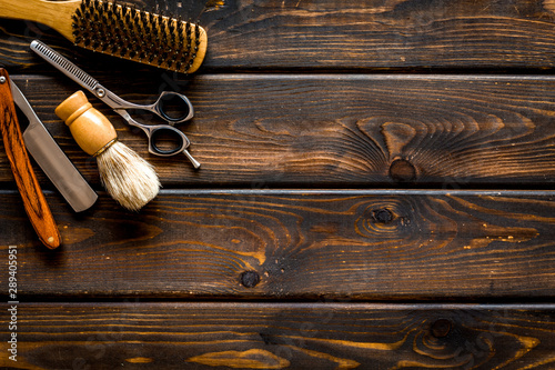 Barbershop concept. Hairdressing tools on dark wooden background top view space for text