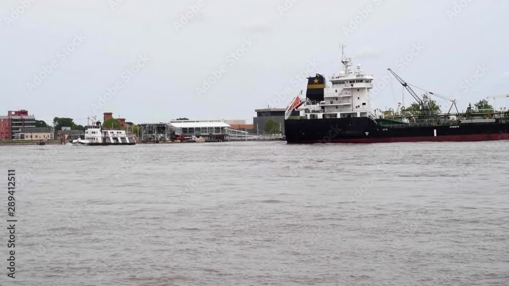 Cargo ship and transport ferry share the same shipping lanes in the Mississippi River at New Orleans, Lousiana. Cargo ship and transport ferry share the same shipping lanes in the Mississippi River at New Orleans, Lousiana.