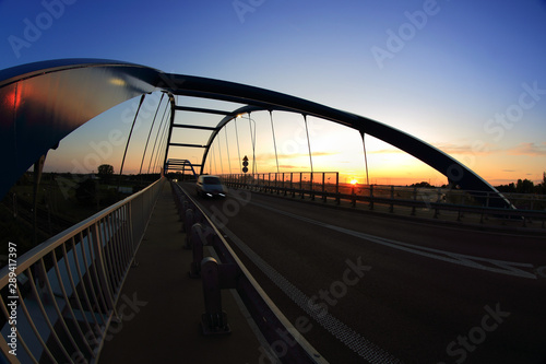 Most wiszący, zachód słońca nad autostradą samochody wieczorem.