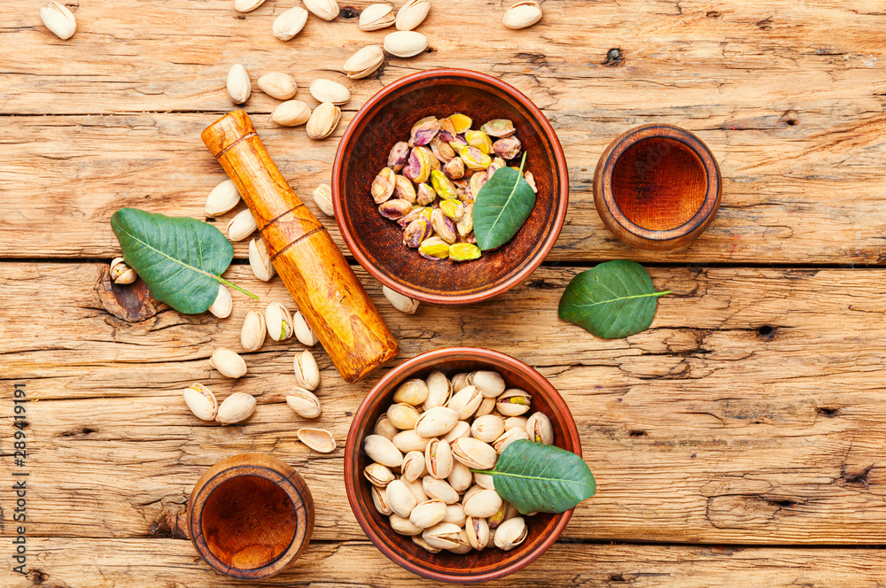 Pistachios nuts on wooden table Pistachios nuts on wooden table
