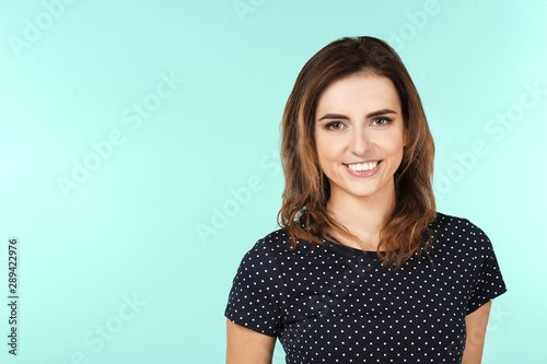 Smiling woman in casual clothes on color background