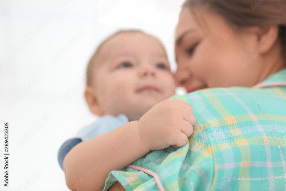 Loving mother with her baby on light background Loving mother with her baby on light background