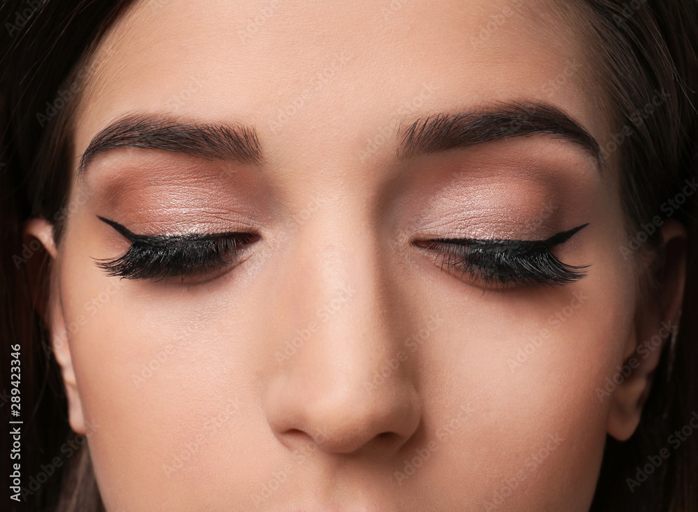 Young woman with elegant makeup and long eyelashes, closeup. Eyelash extensions Young woman with elegant makeup and long eyelashes, closeup. Eyelash extensions