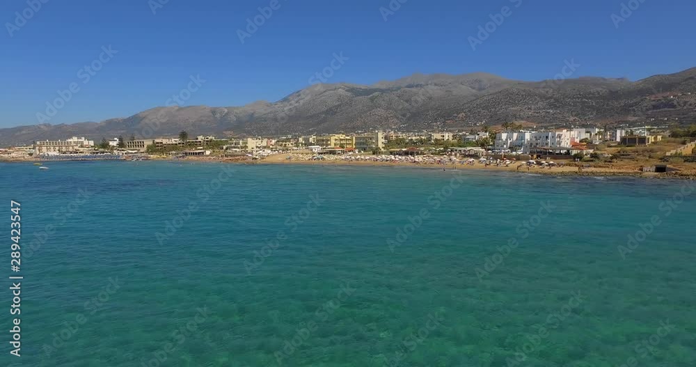 The touristic city of Stalis with beach resorts during summer. Aerial shot. The touristic city of Stalis with beach resorts during summer. Aerial shot.