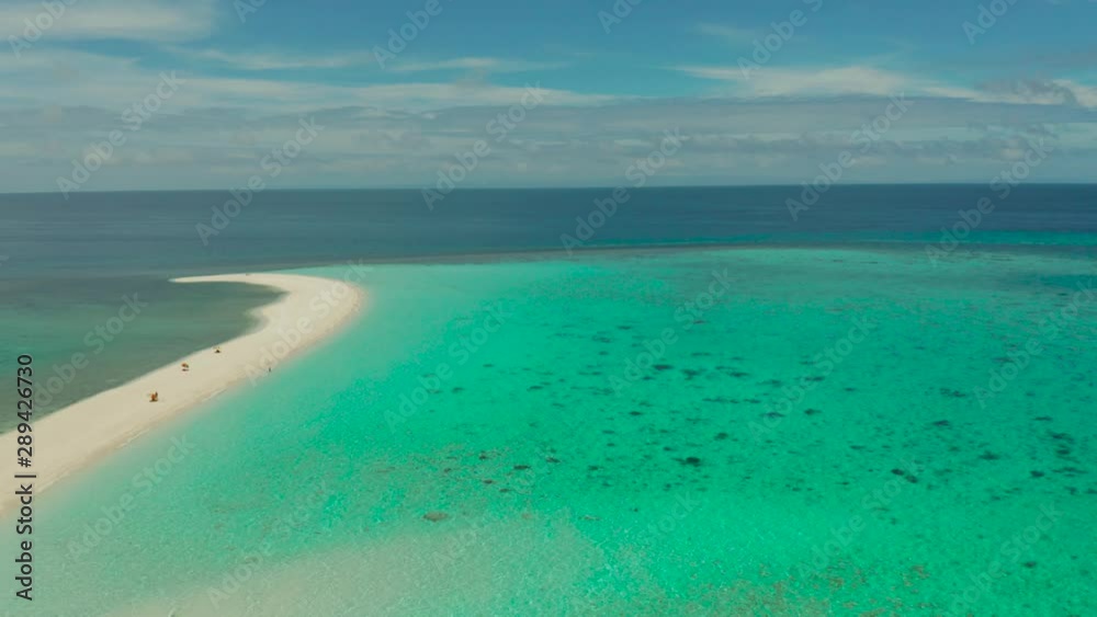 Sand beach island on a coral reef, top view. Atoll with an island of white sand. Sand beach island on a coral reef, top view. Atoll with an island of white sand.