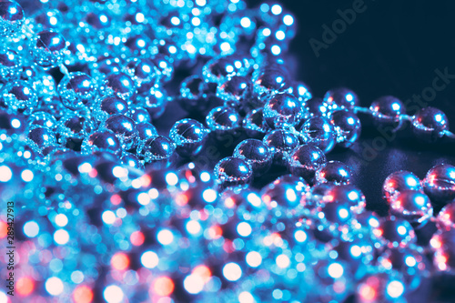 Party or holiday decoration concept - close up of silver shiny beads