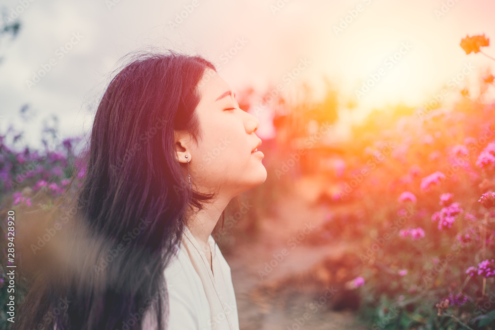 Εκτύπωση καμβά beautiful Asian girl gentle breathing in the flower field sunset beauty moment s
