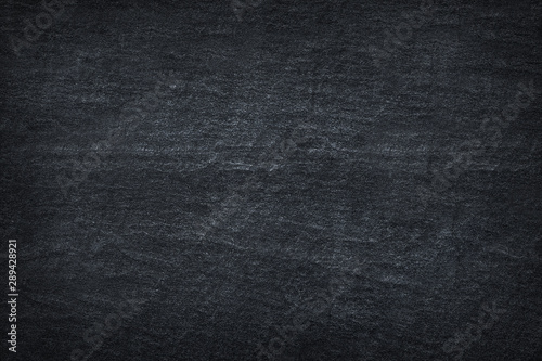 Dark grey black slate stone abstract background or stone texture.