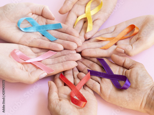 Close-up hands holding colorful awareness ribbons