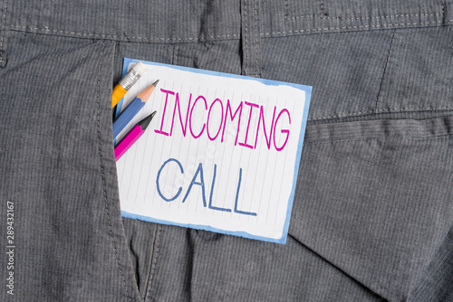 Handwriting text Incoming Call. Conceptual photo Inbound Received Caller ID Telephone Voicemail Vidcall Writing equipment and white note paper inside pocket of man work trousers