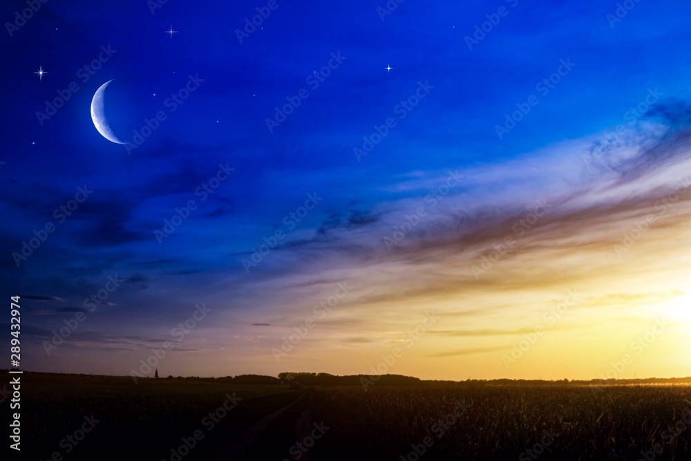 Beautiful dark fluffy cloudy sky with sun rays . Crescent moon with beautiful sunset background . Generous Ramadan . New moon. Prayer time.