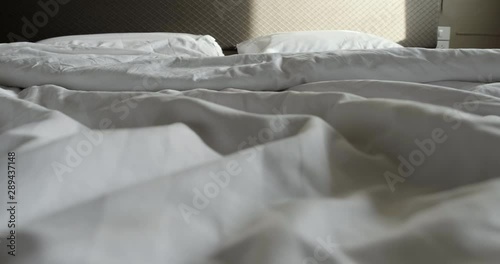  Crumpled messy white blanket untidy, Unmade bed after waking up in the morning with a duvet on the bed.