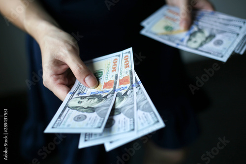 Selective focus of Hand receiving money from businesswoman,Concept of savings, salary, payment and funds.