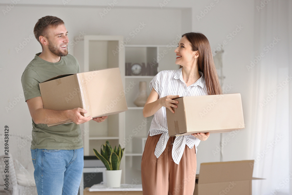 Happy young couple with moving boxes in their new house Happy young couple with moving boxes in their new house