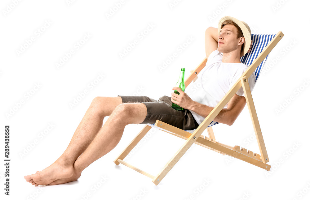 Young man relaxing on sun lounger against white background Young man relaxing on sun lounger against white background