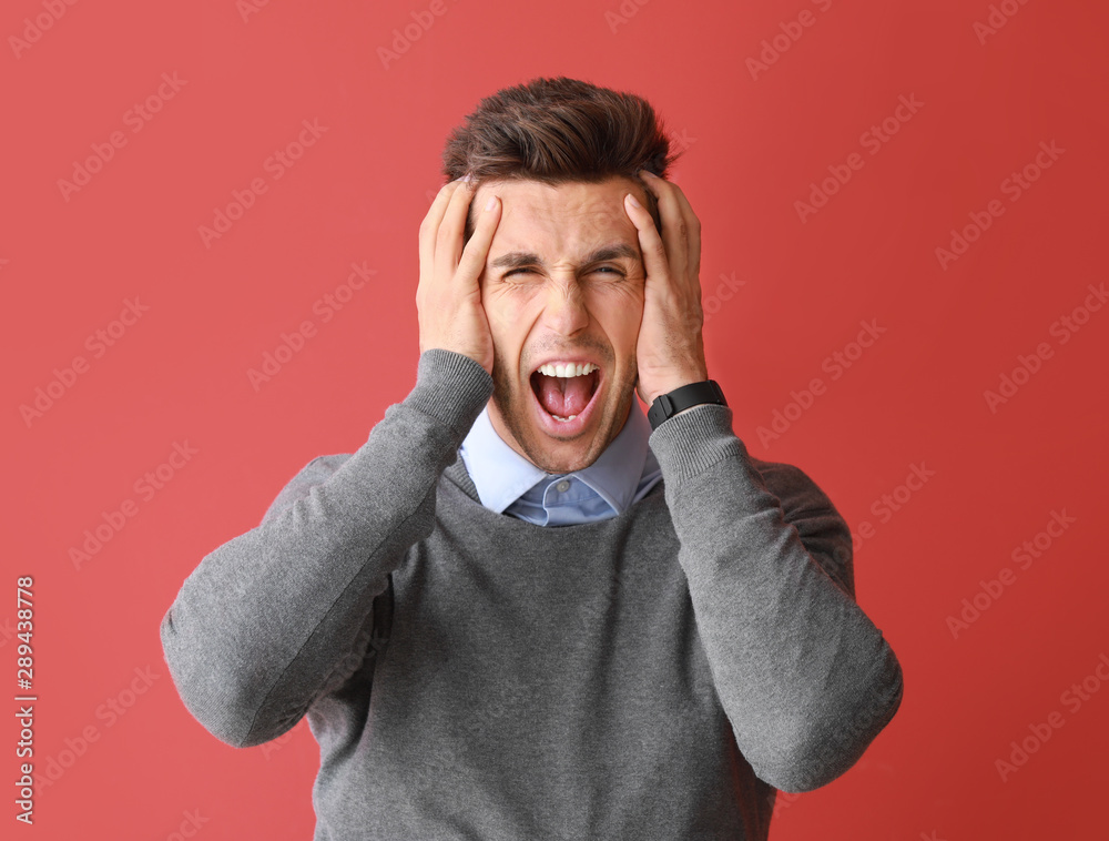 Stressed young man on color background Stressed young man on color background