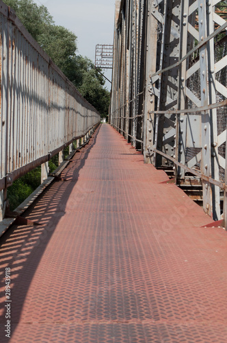 Red pedestrian walkway on the iron bridge