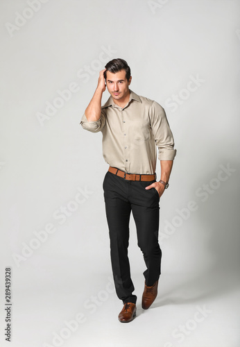 Fashionable man on light background