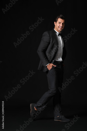 Fashionable man in formal clothes on dark background